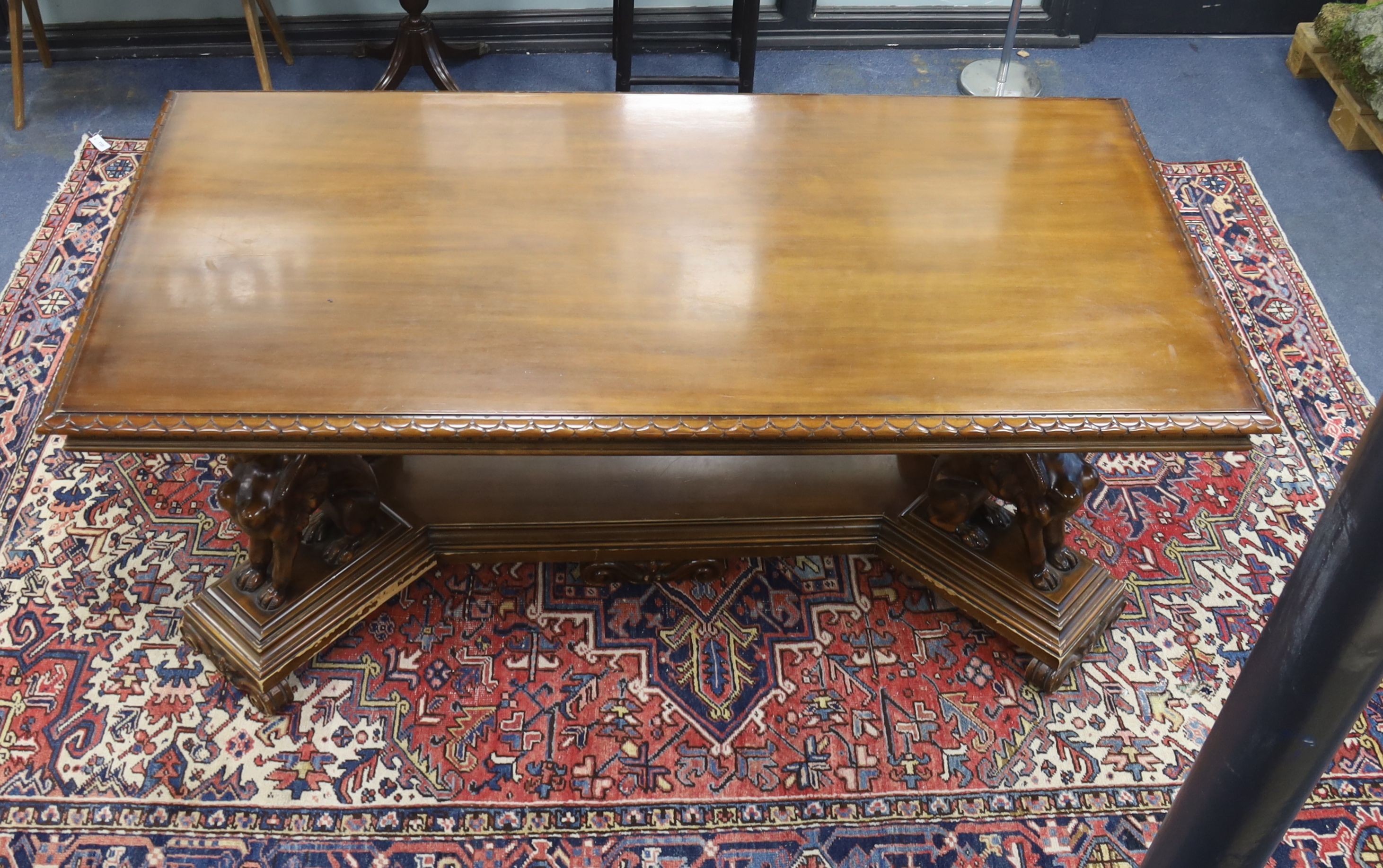 An Italian design rectangular walnut centre table with winged sphinx supports, width 196cm, depth 96cm, height 77cm